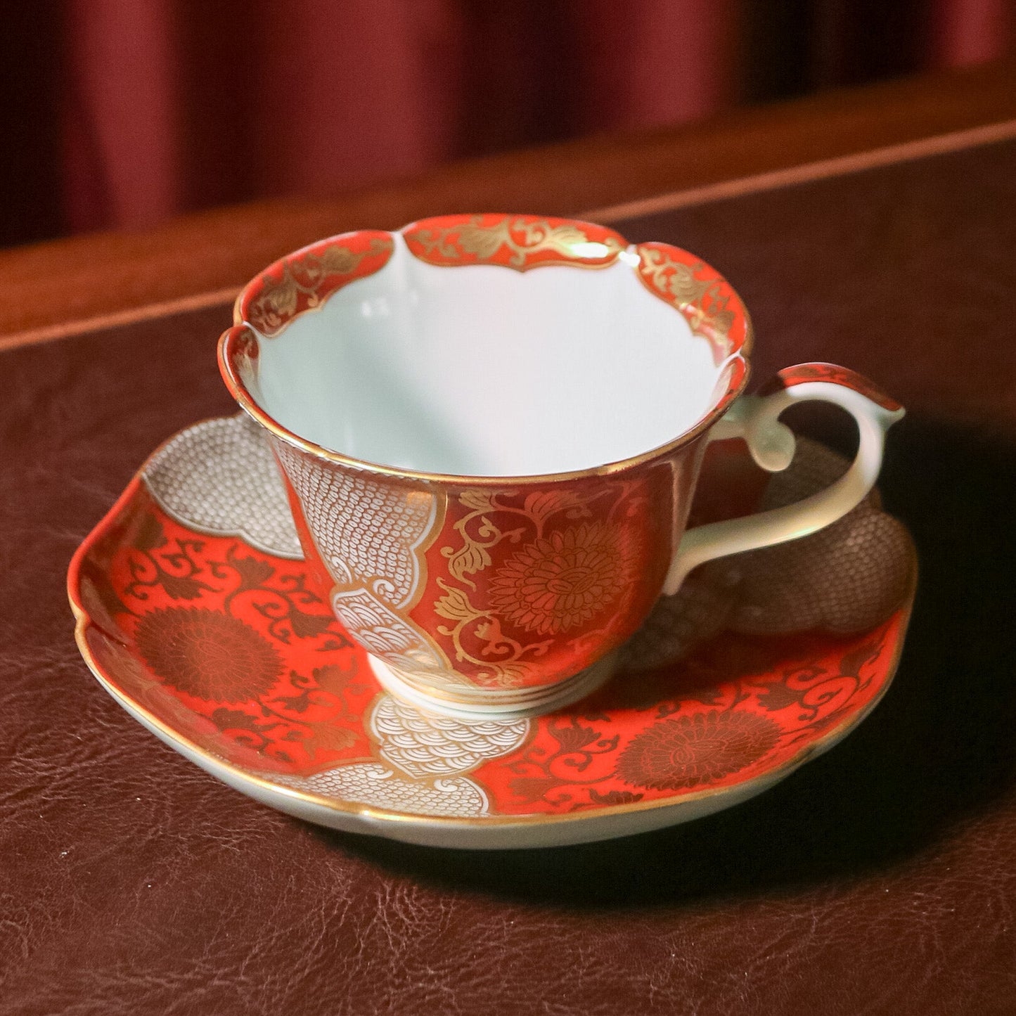 Red and gold chrysanthemum flower tea cup and saucer set (Arita-ware)